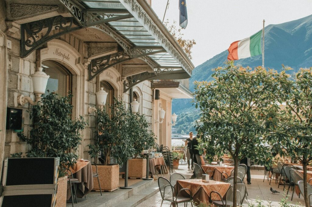 The Hotel Metropole in Bellagio on Lake Como with tables and chairs outside.